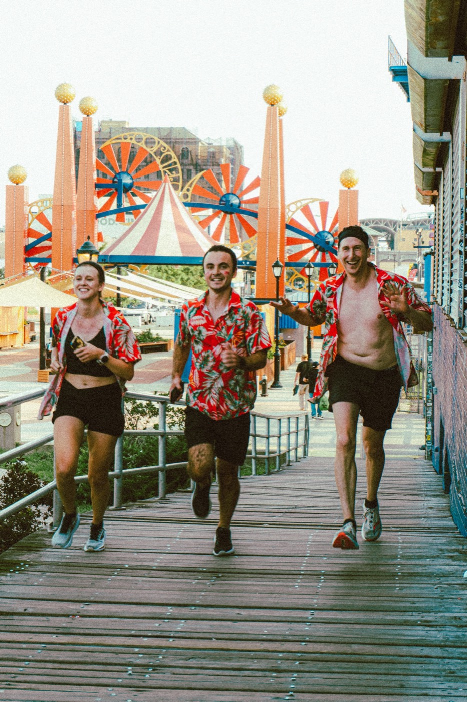 Three runners in matching shirts on the boardwalk at The Warriors 2026